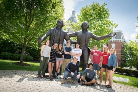 Students pose for pictures with the statues of George Washington and Thomas Jefferson during the Creosote Affects photo shoot May 1, 2019 at Washington & Jefferson College.